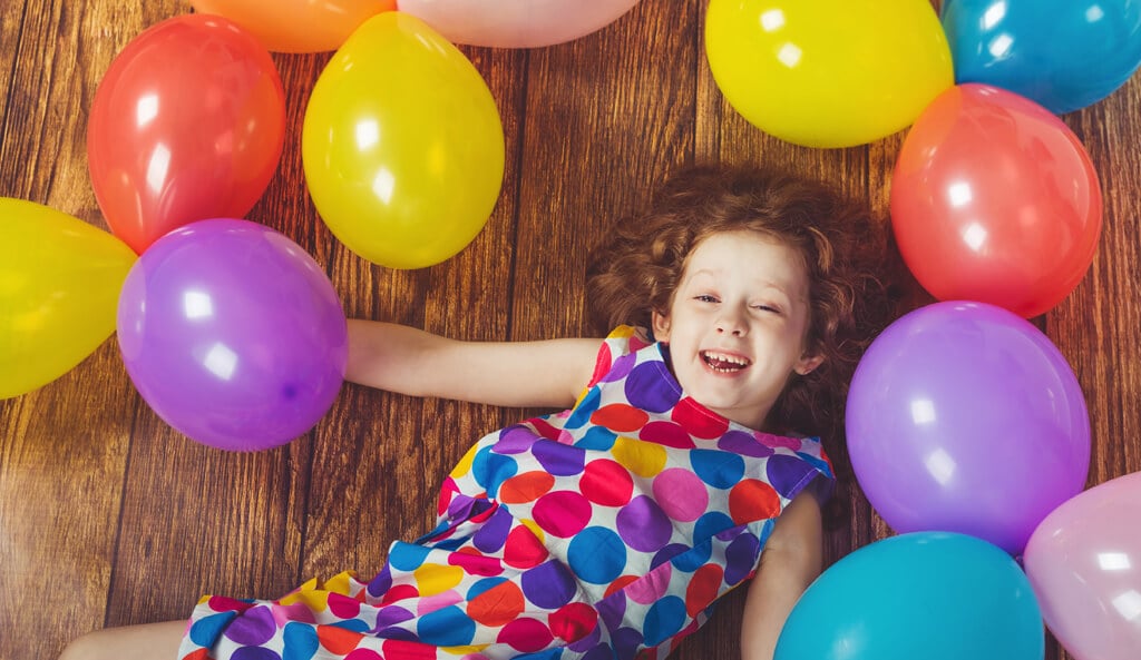 A child playing among balloons, featured by Cerebra