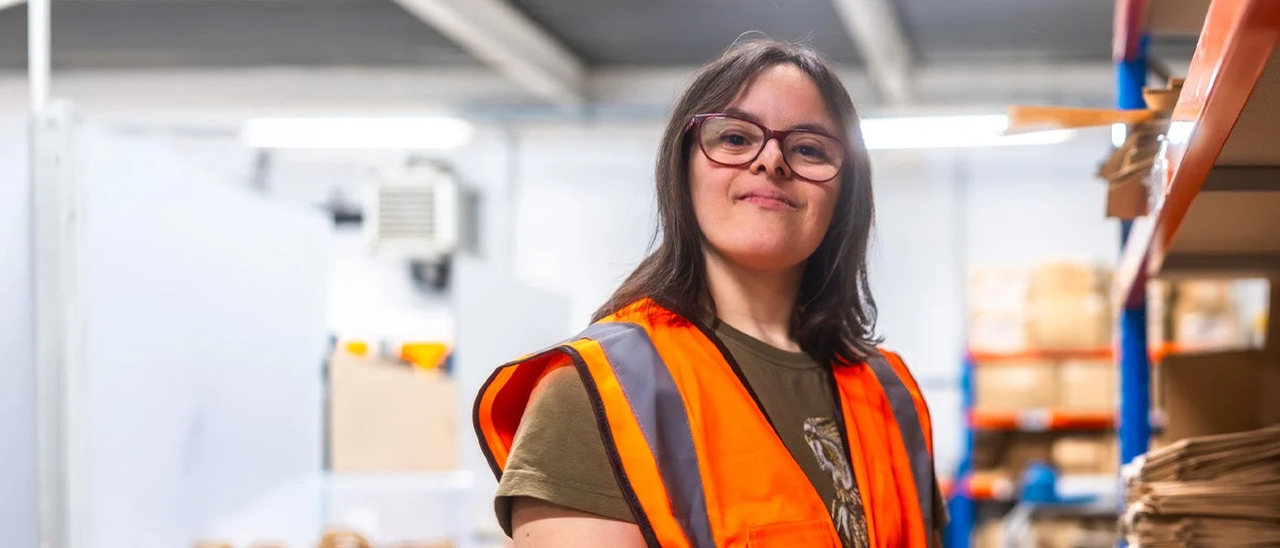 A disabled woman at work in a warehouse